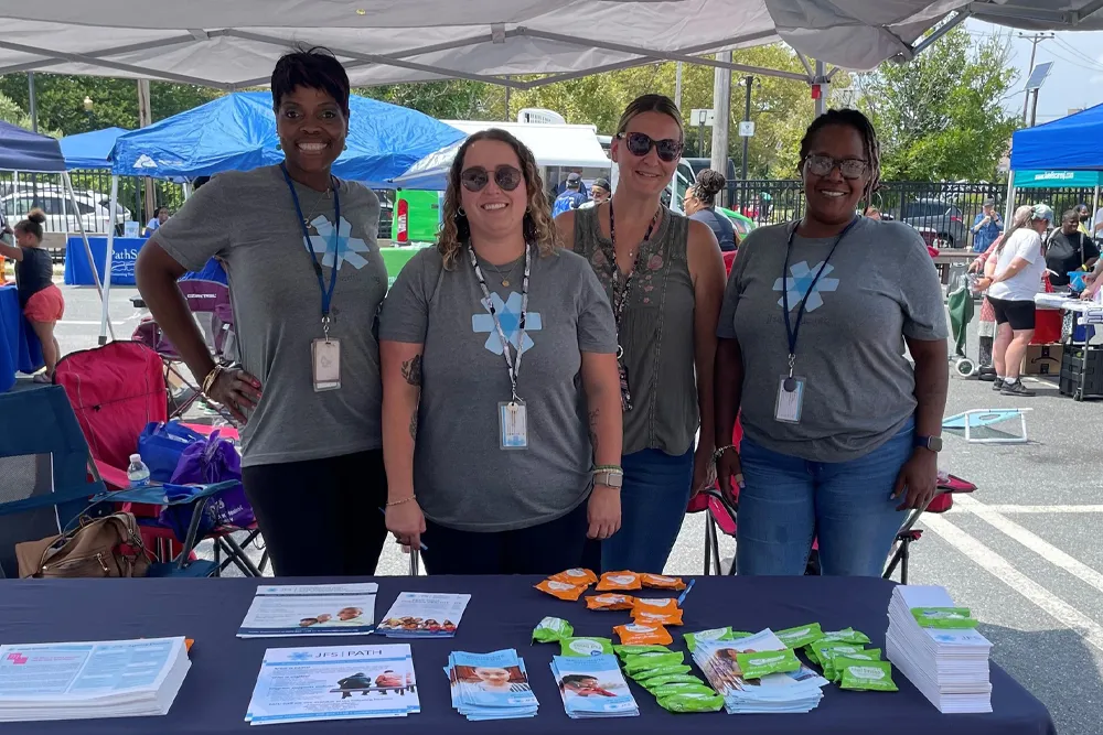 group of volunteers at a JFS event tent