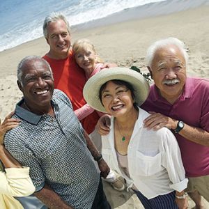 group of smiling seniors on the beach