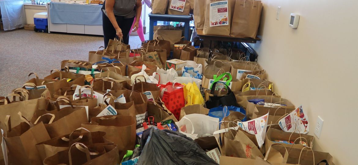 JFS Volunteer Mindy Goldberg sorts through donations from the High Holidays Food Drive