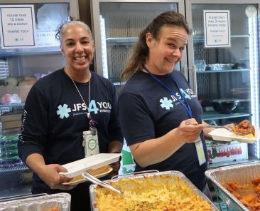 JFS Staff Members Liz Lovinsky and Bailey Pokres enjoy an International Food Day event